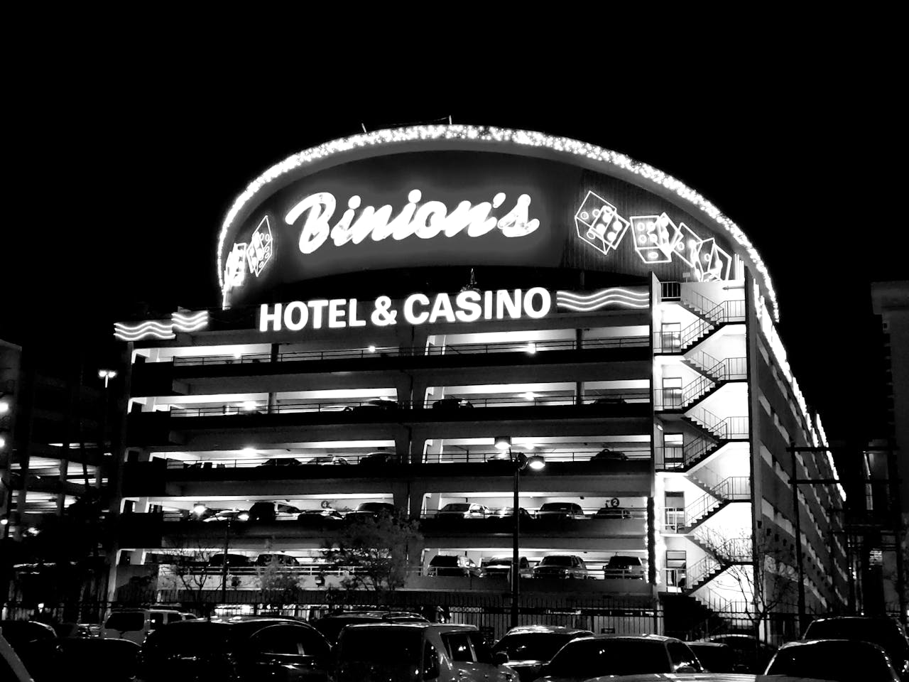 Black and white image of Binion's Hotel & Casino facade lit up at night in Las Vegas.